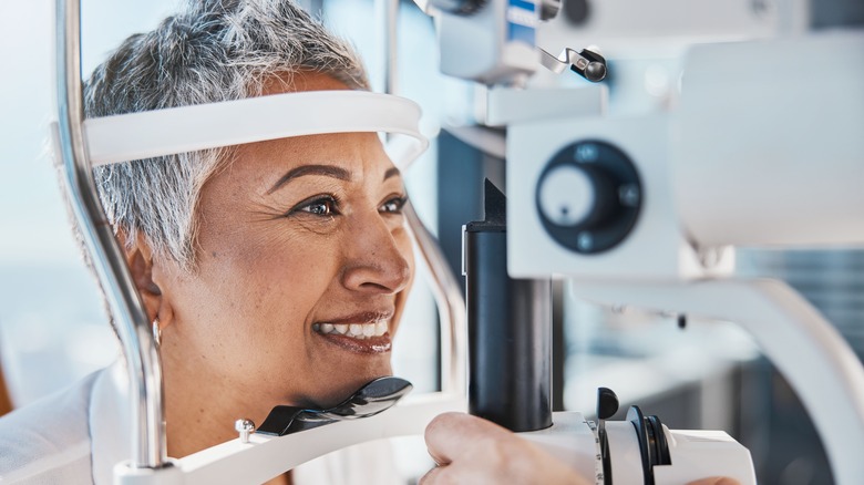 Smiling woman looking into eye X-ray