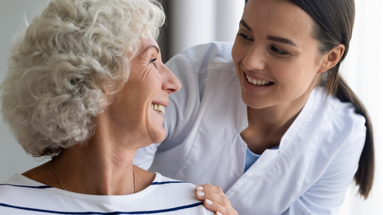 Home health aide comforting woman