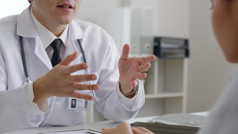 Doctor educating patient at home