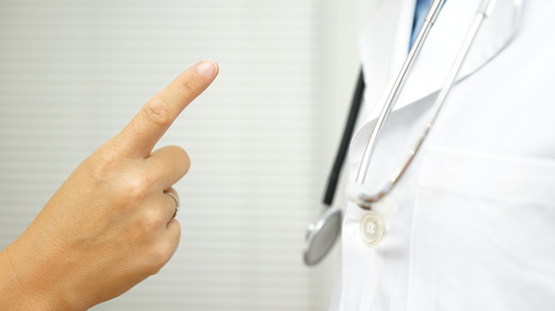 patient finger pointing at doctor