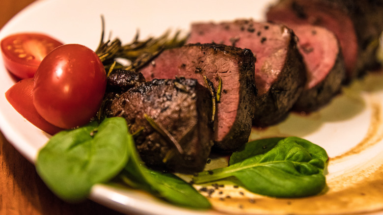 sliced kangaroo steak on platter