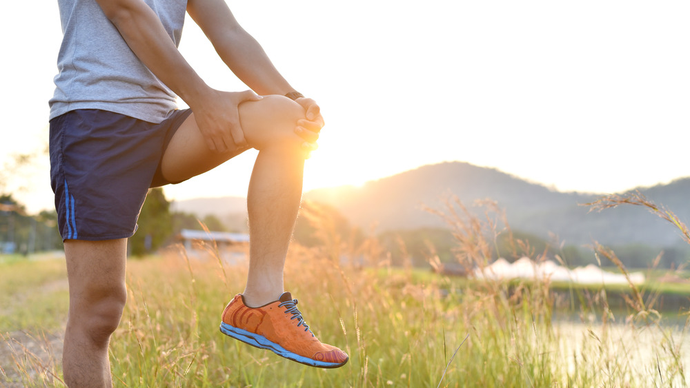 man stretching leg