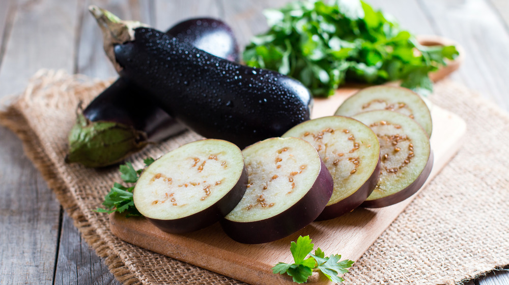 sliced eggplant and two whole eggpalnts