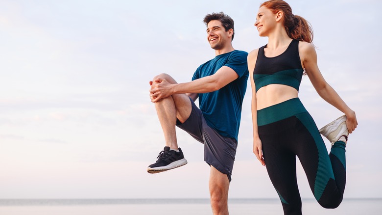 Man and woman stretching