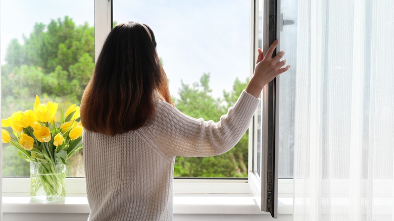 Woman opening a window