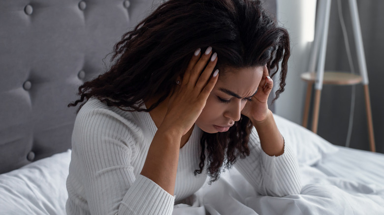 young african american women holding head in pain