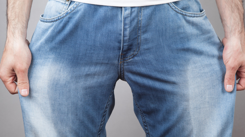 close up of man in wet jeans from urinary leaking