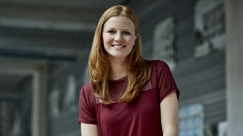 Individual wearing a dark red shirt