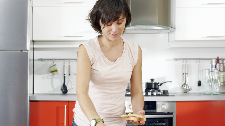 Woman preparing a sandwich at home