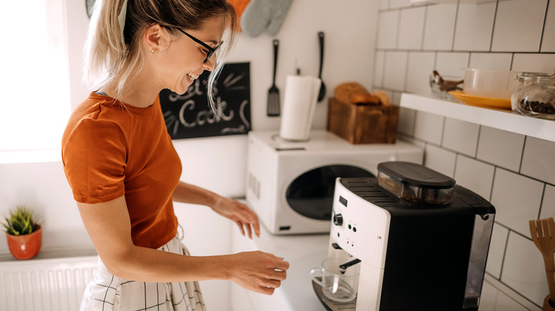 Woman making coffee at home