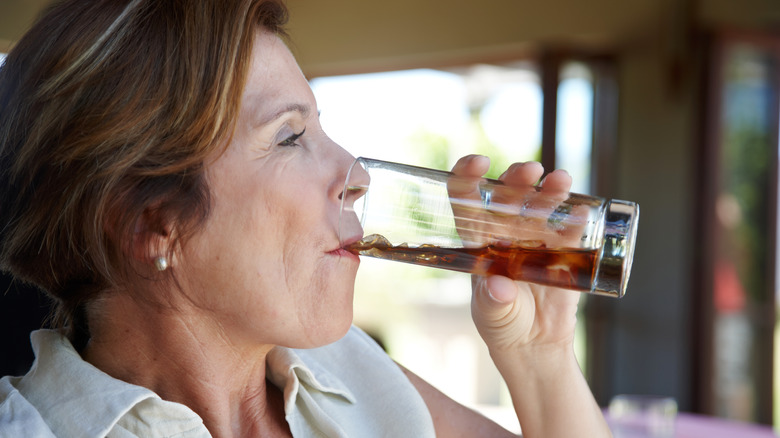 Mature woman drinking soda