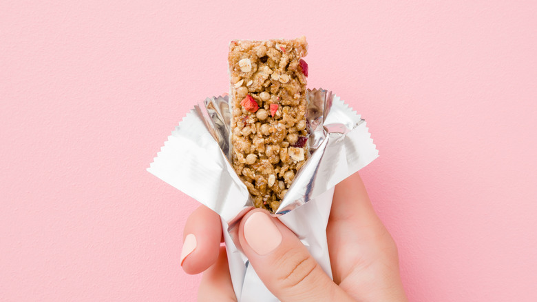 person holding cereal bar