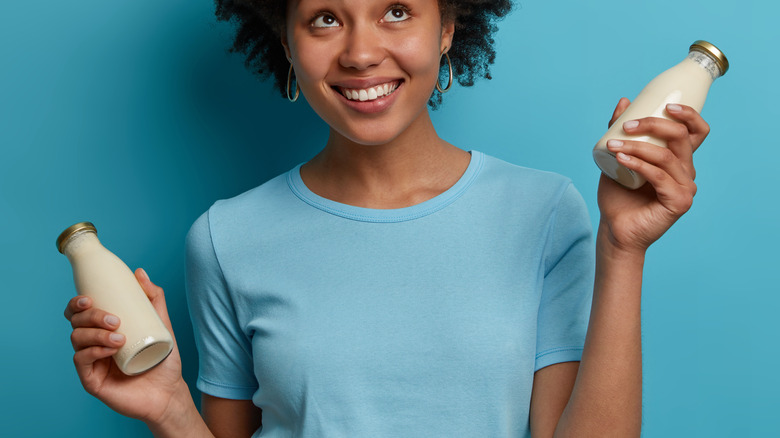 woman holding lactose-free milk