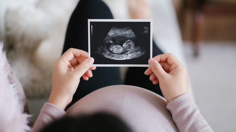 Pregnant woman looks at a mammogram 