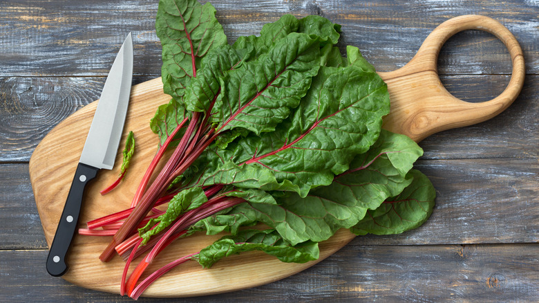 cutting board with Swiss chard leaves