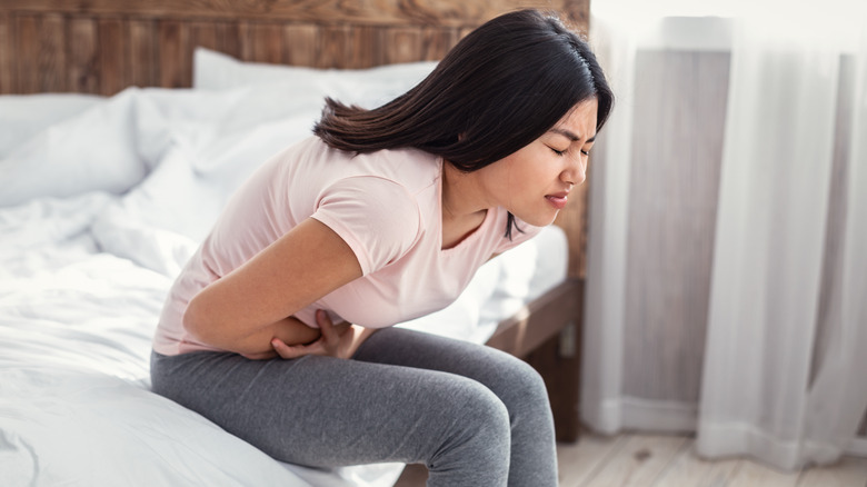 Woman leaning over with cramps