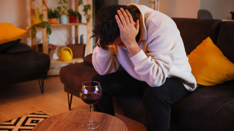 Sad man glass wine table