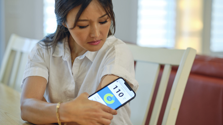 Woman checking blood sugar level