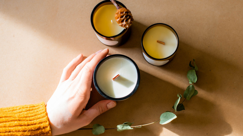 three natural wax candles