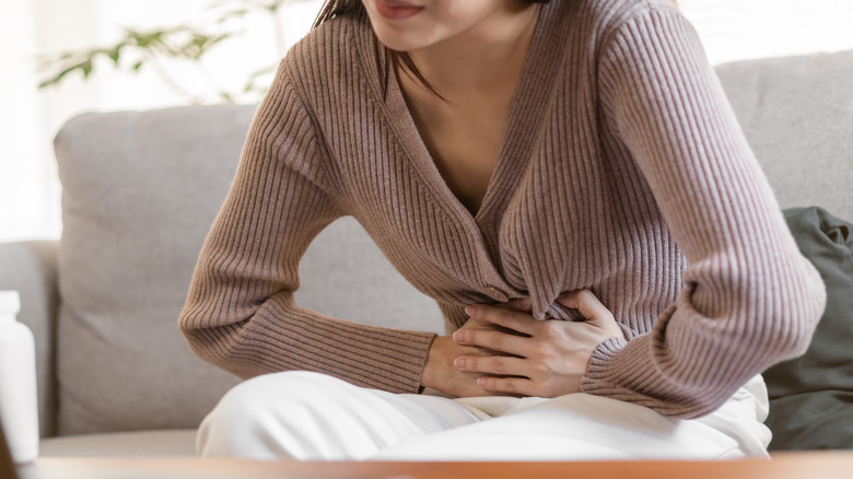 woman holding stomach