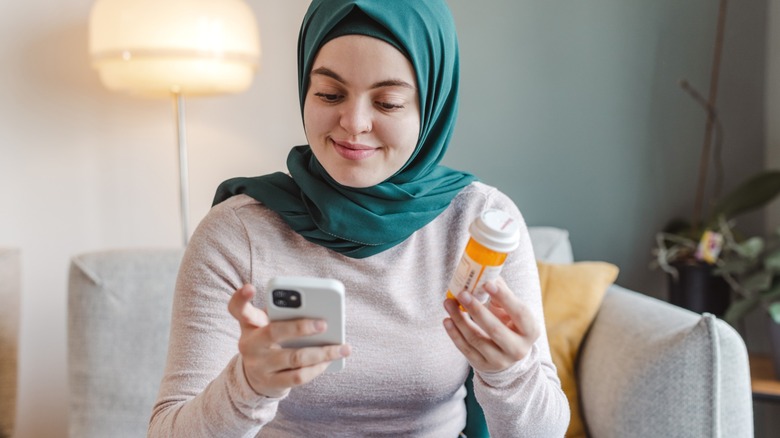 muslin woman researches medication side effects