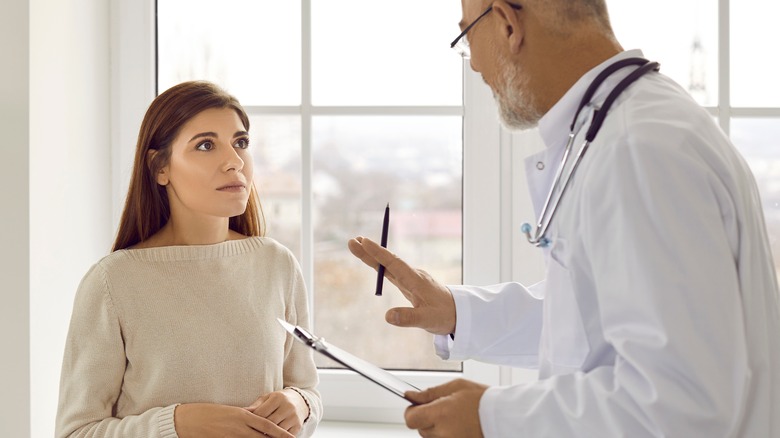 Nervous woman talking to doctor