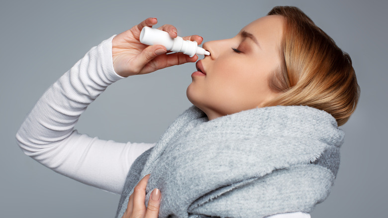 Woman with nasal spray in hand