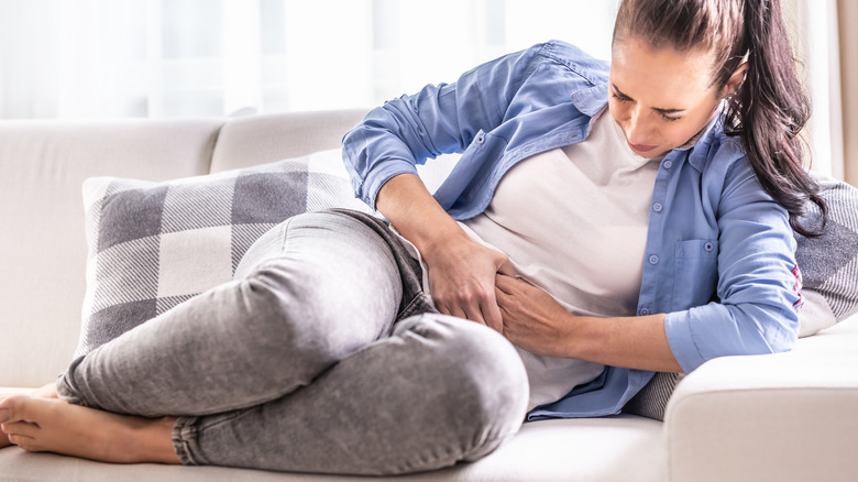 Woman curled up on the couch