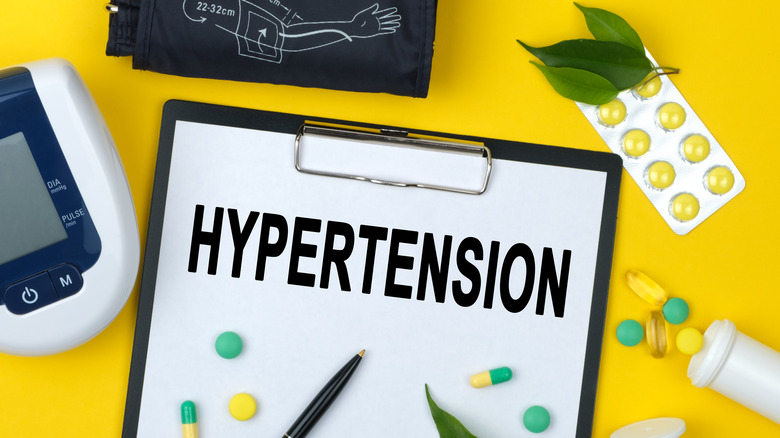 word hypertension, pills, blood pressure cuff
