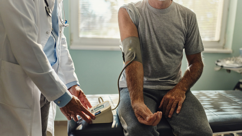 Man at doctor having his blood pressure checked