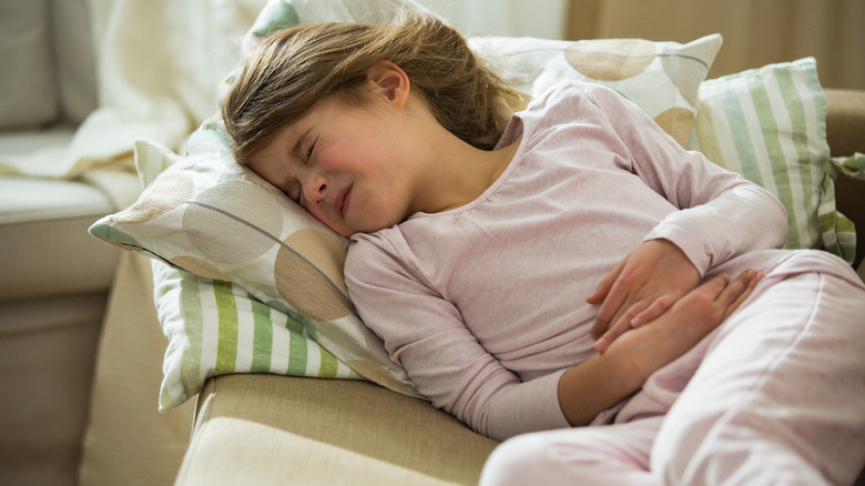 Child with stomach flu lying down