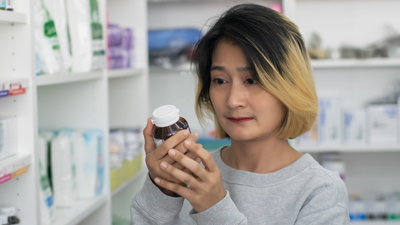 Woman reading medication side effects