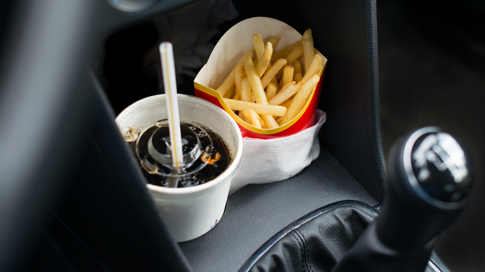 French fries and soda in a car