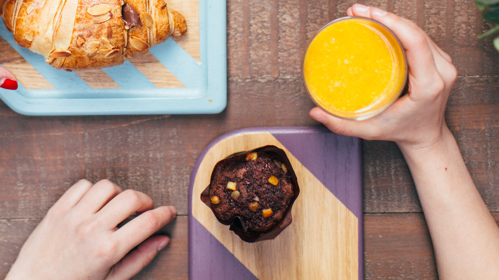 Orange juice and muffin on a table