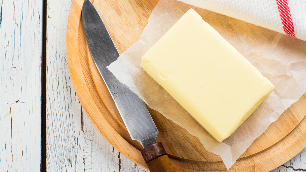 opened stick of butter on cutting board