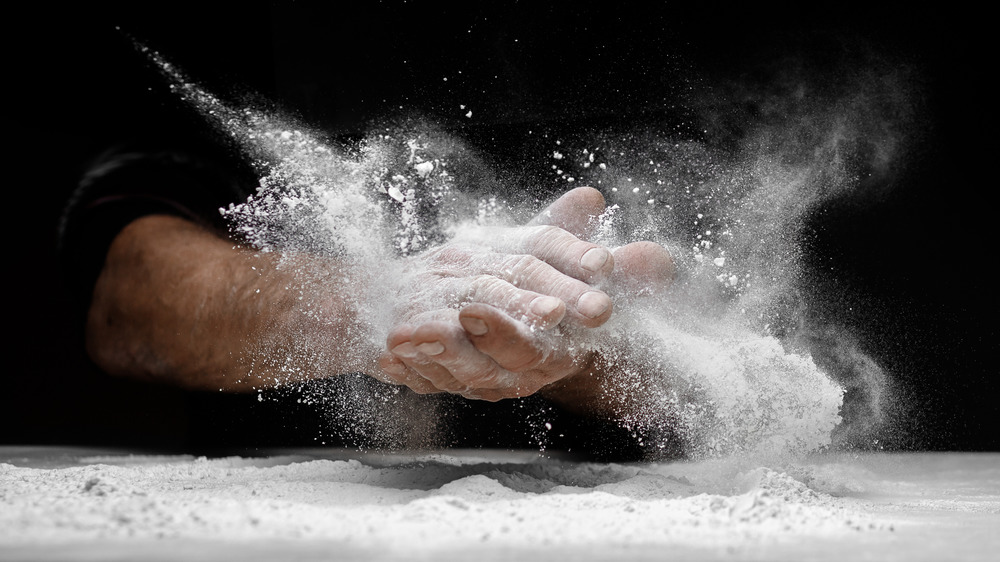 Man clapping hands in flour