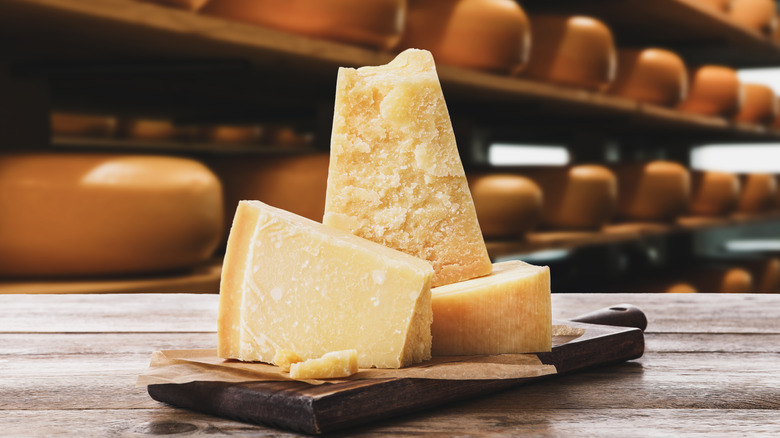 Grana Padano Cheese wedges on wooden table