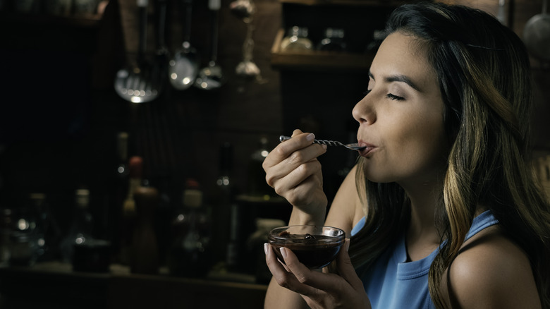 woman eating pudding