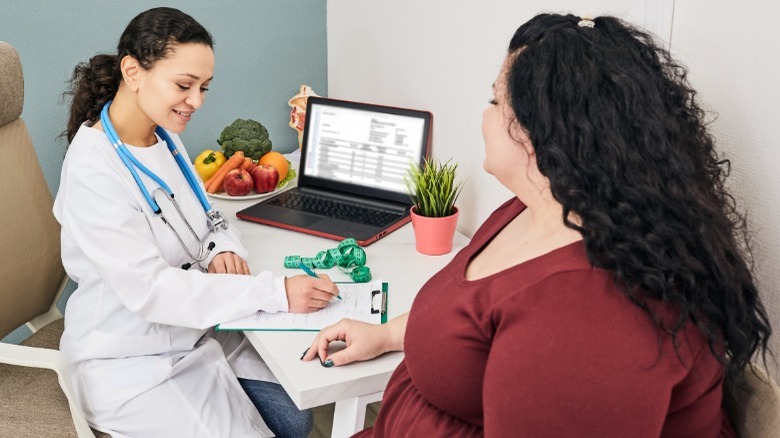 Doctor with overweight patient