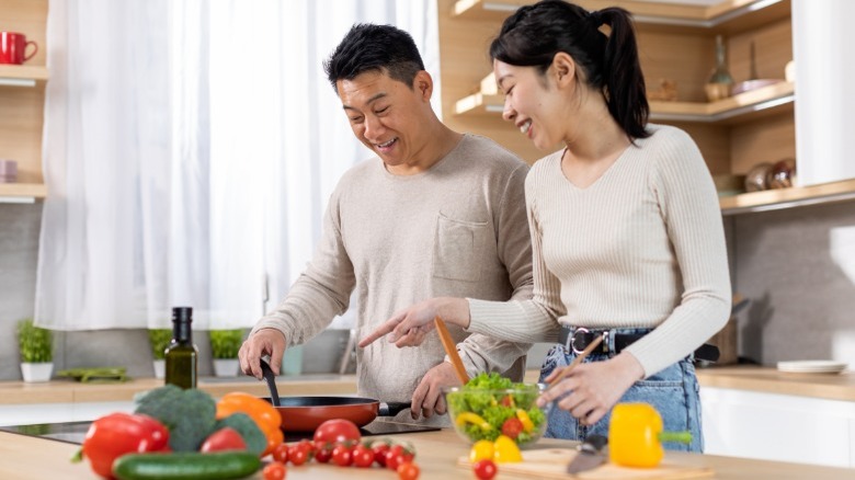 Asian couple prepares healthy meal