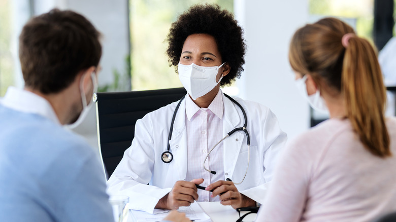 Couple talking to doctor about fertility