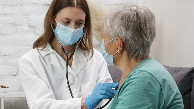 Doctor checking patient's heart rate