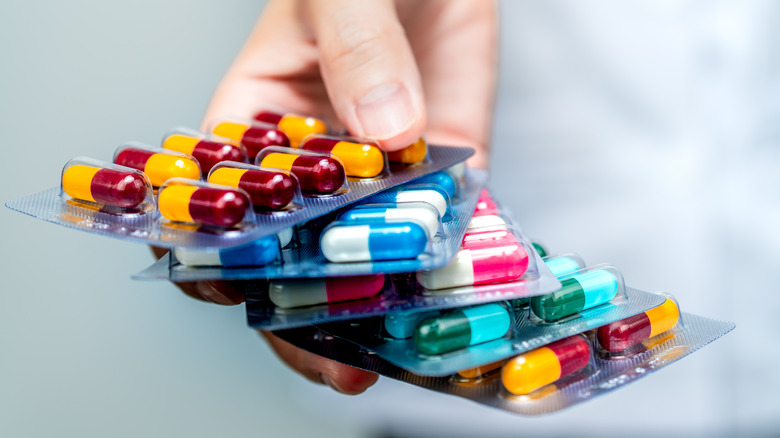 hand with assorted antibiotics