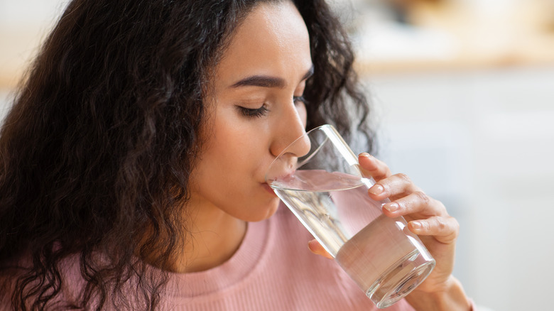 girl drinking glass of water