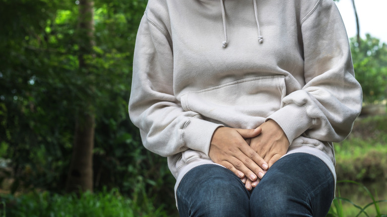 sitting person suffering from uti