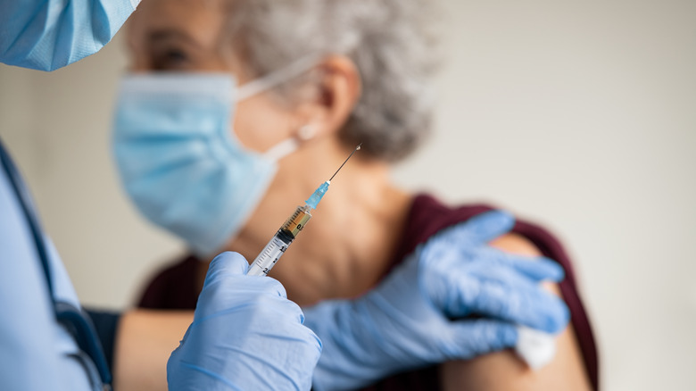 elderly woman getting a vaccine