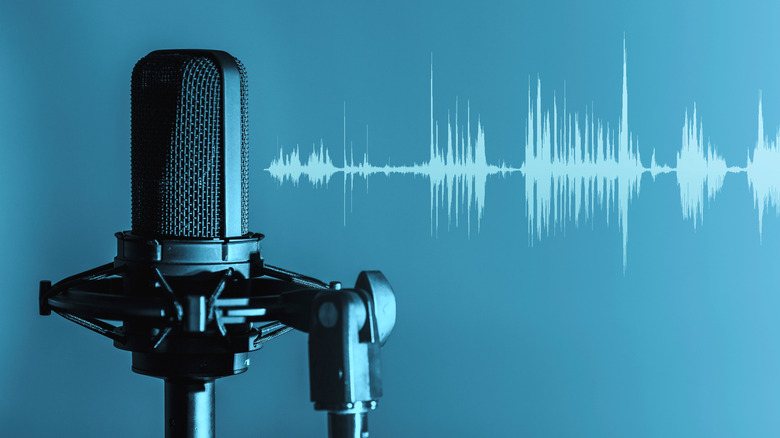 Microphone with light blue sound waves against blue background