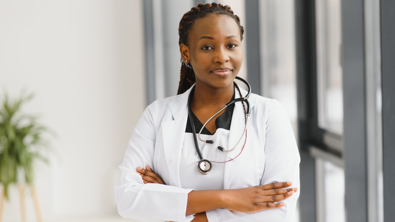 A female doctor standing with her arms crossed