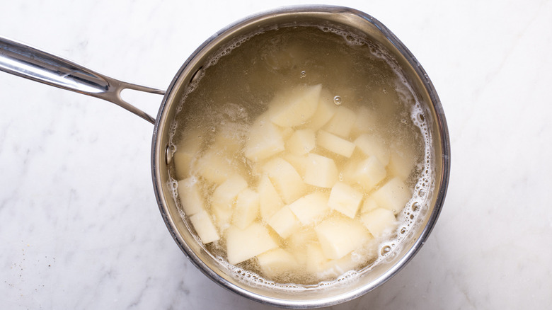chopped potatoes in water pot