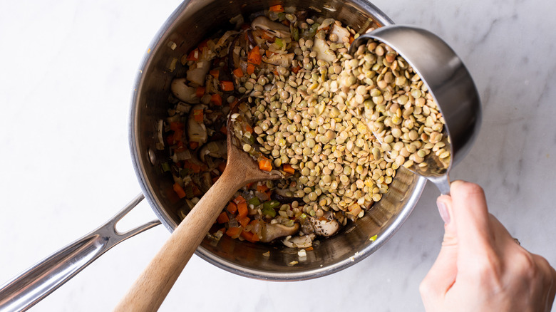 pouring lentils into pot